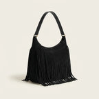 Black vintage fringe hobo bag, three-quarter angle showing side depth