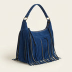 Blue vintage fringe hobo bag, three-quarter angle showing side depth