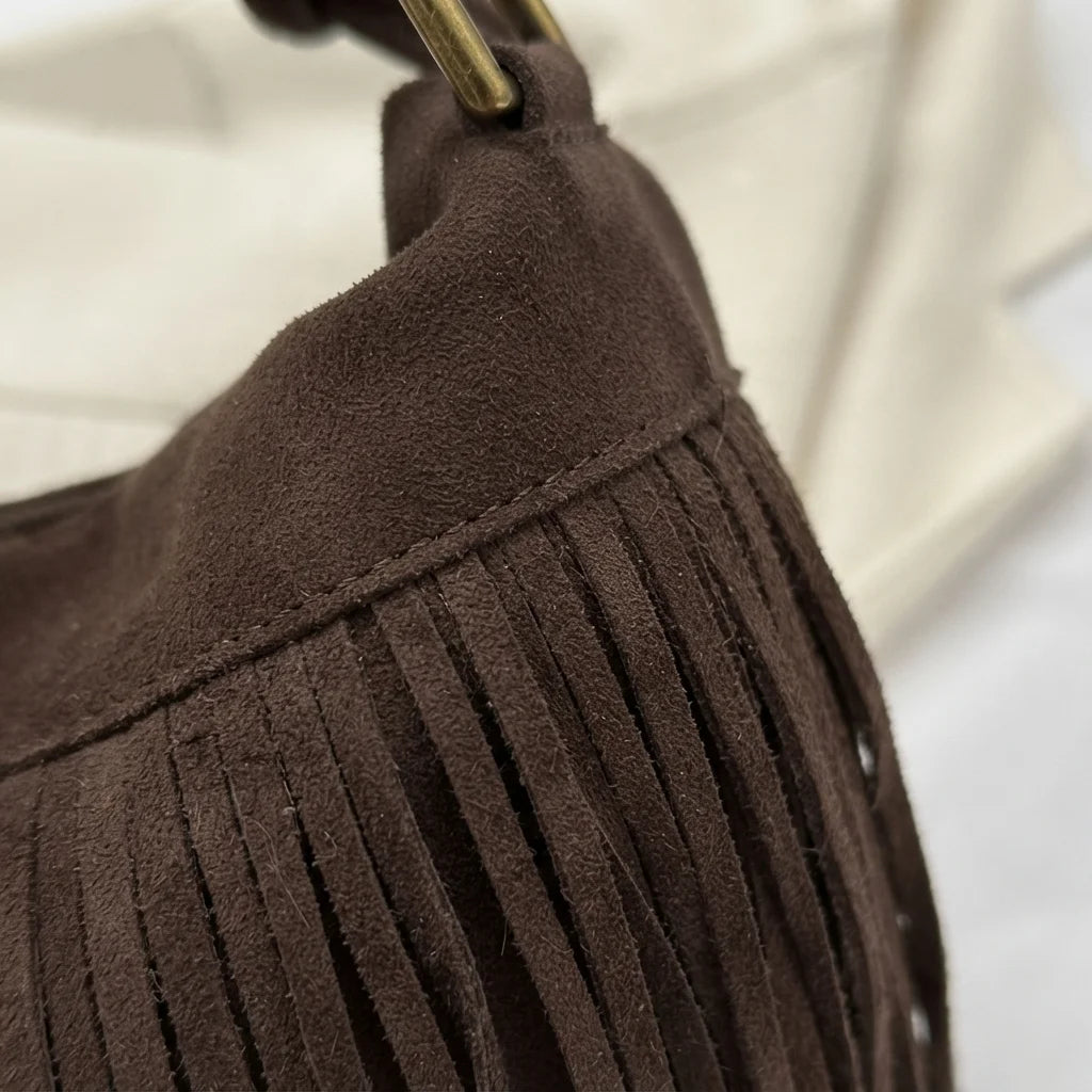 Close-up of fringe stitching and texture on Coffee vintage suede fringe bag