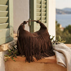 Coffee vintage suede fringe bag styled in a warm Mediterranean setting