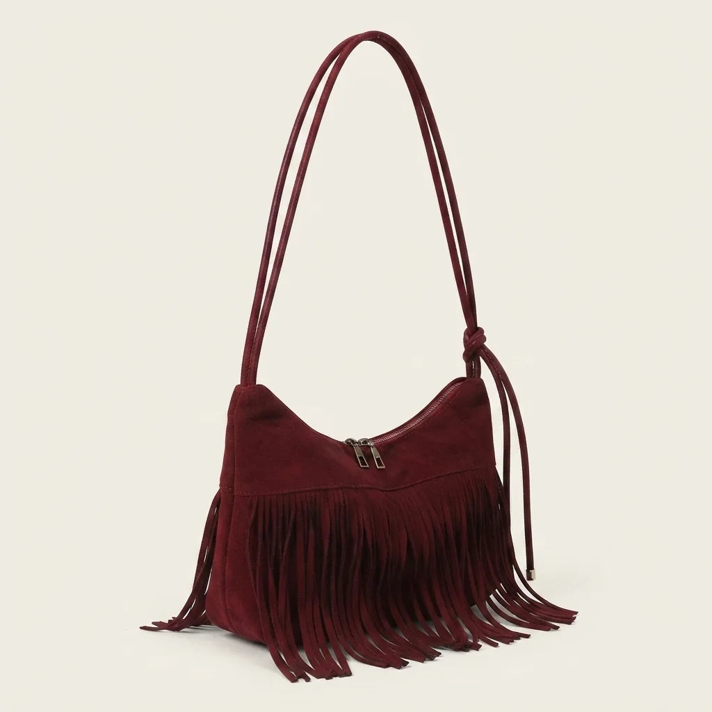 Red vintage suede fringe bag, three-quarter angle showing side depth