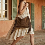 Woman wearing Coffee western fringed hobo bags with swaying fringe