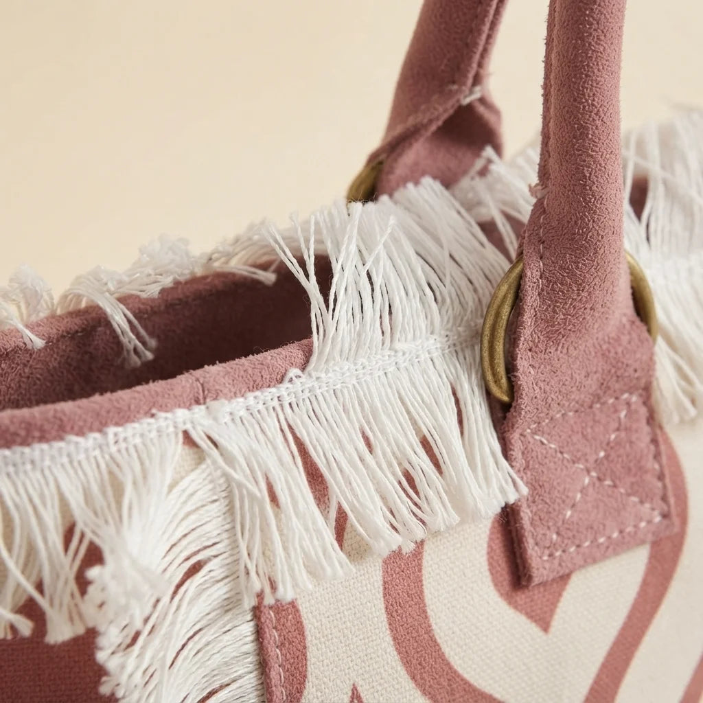 Close-up of fringe stitching and texture on Pink & White white fringe beach bag