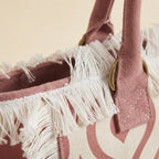 Close-up of fringe stitching and texture on Pink & White white fringe beach bag