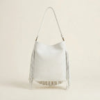Back panel of White white fringe bucket bag with strap attachments