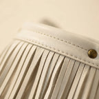 Close-up of fringe stitching and texture on White white fringe bucket bag