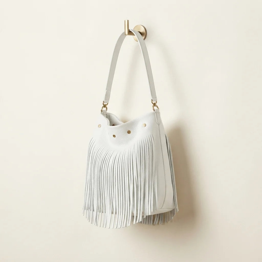 White white fringe bucket bag, three-quarter angle showing side depth