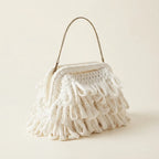 White white fringe clutch bag, three-quarter angle showing side depth