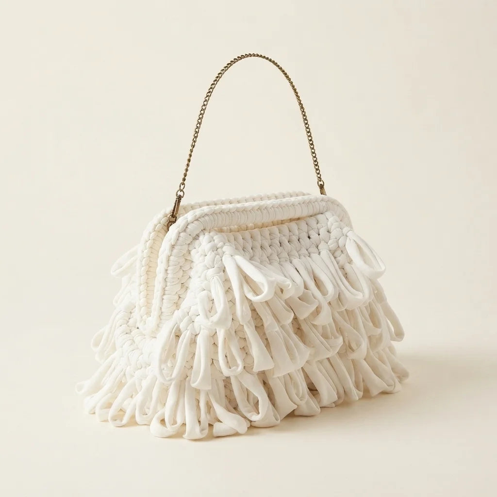 White white fringe clutch bag, three-quarter angle showing side depth