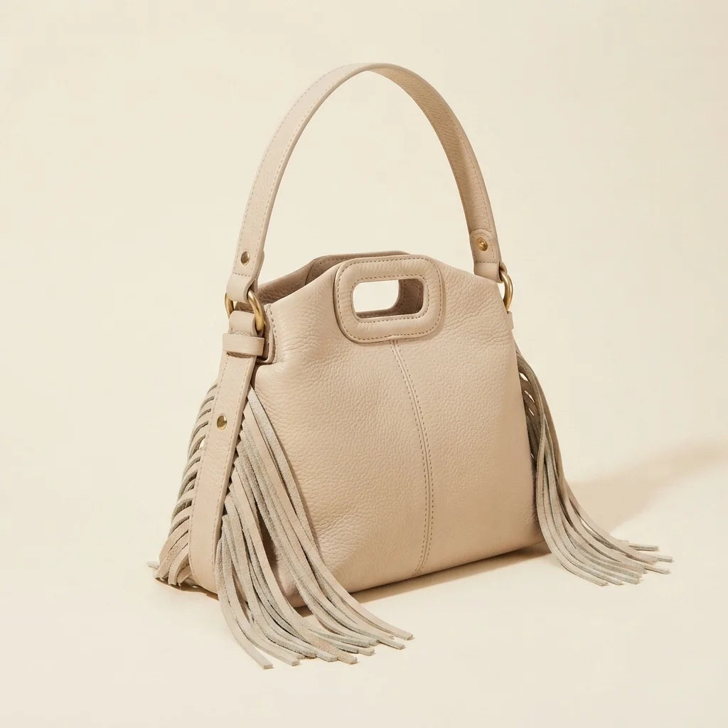 Cream white fringe shoulder bag, three-quarter angle showing side depth
