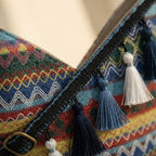 Close-up of fringe stitching and texture on Blue woven fringe bag
