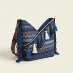 Blue woven fringe bag, three-quarter angle showing side depth
