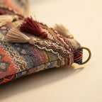 Close-up of fringe stitching and texture on Wine Red woven fringe bag