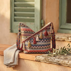 Wine Red woven fringe bag styled in a warm Mediterranean setting