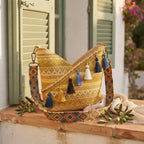 Yellow woven fringe bag styled in a warm Mediterranean setting