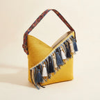 Yellow woven fringe bag, three-quarter angle showing side depth