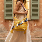 Woman wearing Yellow woven fringe bag with swaying fringe