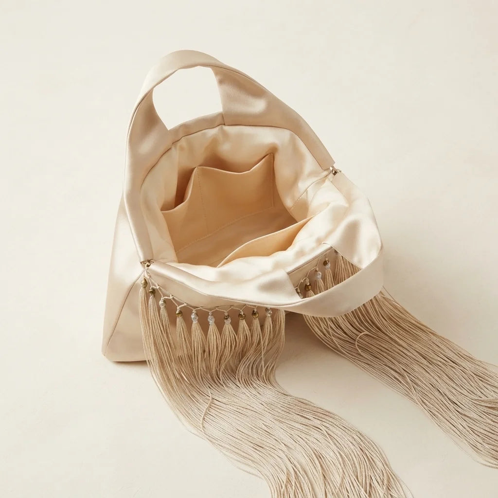Interior lining and pockets of Beige wristlet fringe bag